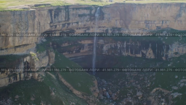 High waterfall among the stone walls. Republic of Dagestan, Russia. The concept of traveling in your country. Стоковое видео, видеограф Воловодов Владимир / Фотобанк Лори