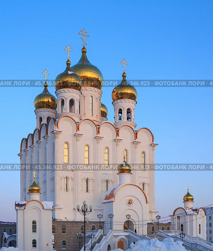 Holy Trinity Cathedral. Large Orthodox Church. Beautiful white building with golden domes and crosses against a blue sky. Cold winter. Magadan, Siberia, Far East of Russia. Стоковое фото, фотограф Андрей Степанов / Фотобанк Лори