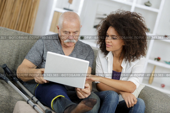homecarer with elderly woman using laptop computer. Стоковое фото, агентство Ingram Publishing / Фотобанк Лори