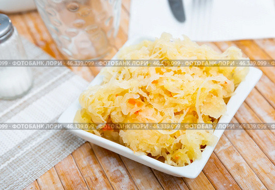 Homemade pickled cabbage on white plate closeup, natural probiotic. Стоковое фото, фотограф Яков Филимонов / Фотобанк Лори