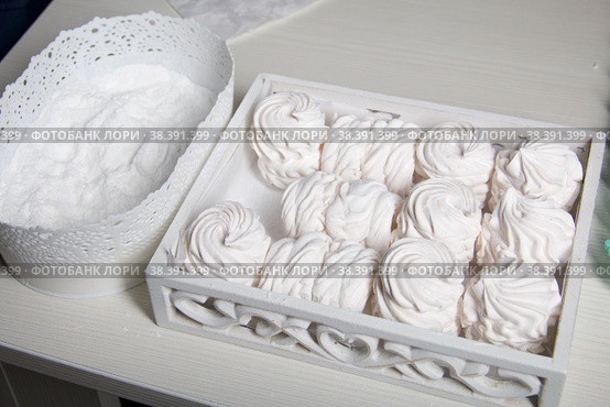 Homemade zephyr. White tray with marshmallows. Nearby is a container of dextrose. For processing marshmallows. Стоковое фото, фотограф Vadzim Yakubovich / Фотобанк Лори