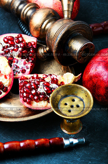 hookah with pomegranate. Exotic smoking shisha in east style with tobacco aroma of pomegranate.Fruit hookah. Стоковое фото, агентство Ingram Publishing / Фотобанк Лори