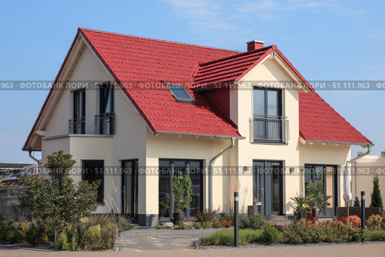 House Exterior. Roof Window. Second floor among blue sky. Mansard attic. Newly build houses. Gable roof with skylight, asphalt roofing, shingles. Residential Home. Vinyl Siding. Polymeric roof-tiles. Стоковое AI-изображение, AI-художник Марина Демидюк / Фотобанк Лори