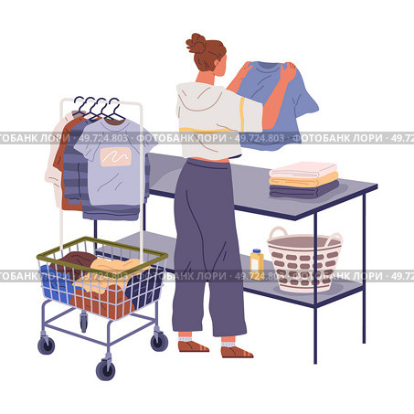 Housewife doing housework hangs washed clothes on hanger. Woman decluttering and organizing wardrobe, putting clothes into Sale and Trash boxes. Person taking inventory and sorting out apparels. Housewife doing housework hangs washed clothes on hanger. Woman decluttering and organizing wardrobe. Стоковая иллюстрация, агентство Ingram Publishing / Фотобанк Лори