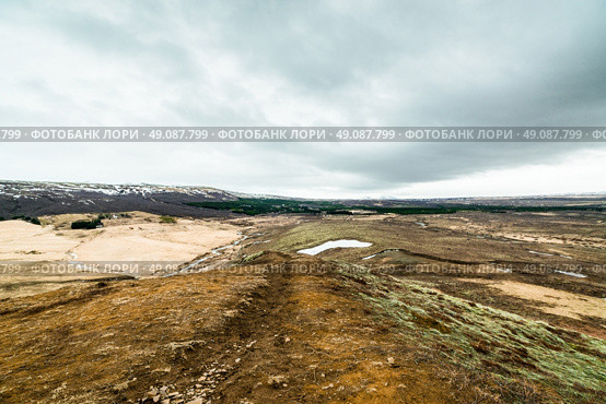 Iceland landscape with mountains in the horizont and cloudy weather. Стоковое фото, агентство Ingram Publishing / Фотобанк Лори