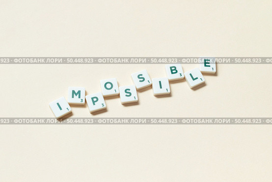 Impossible word formed of scrabble tiles on beige background. Simple creative backdrop for business presentation.. Impossible formed of scrabble tiles on beige background. Стоковое фото, агентство Ingram Publishing / Фотобанк Лори