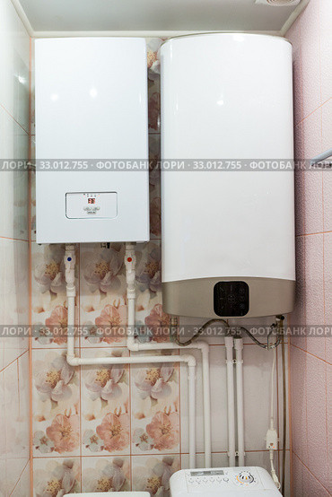 Independent heat-recovery boiler with hot water tank, domestic heating system. Стоковое фото, фотограф Кекяляйнен Андрей / Фотобанк Лори