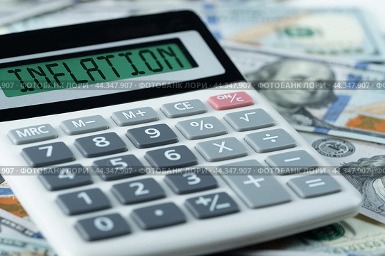 Inflation text on calculator on us dollars background. calculation of price increases, the cost of products and goods. Monetary Inflation. Стоковое фото, фотограф Павел Муравьев / Фотобанк Лори