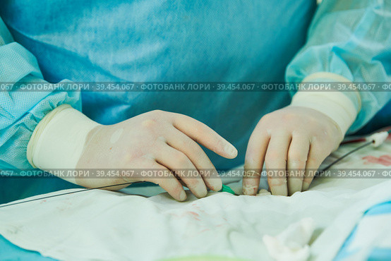 Interventional radiology. surgeon radiologist at operation during catheter based treatment with X-ray visualization. Стоковое фото, фотограф Дмитрий Калиновский / Фотобанк Лори