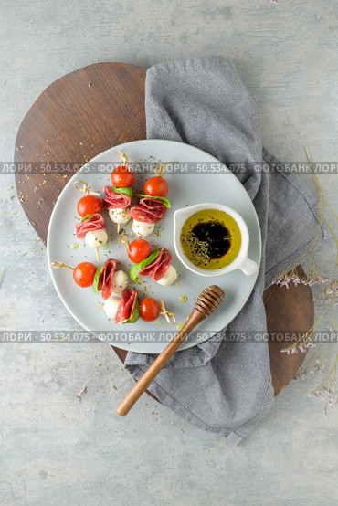 Italian style appetizer, antipasto skewer or caprese on a stick with basil, salami, mozarella and tomatoes. Стоковое фото, агентство Ingram Publishing / Фотобанк Лори