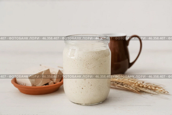 Jar with sourdough on white wooden background. Стоковое фото, фотограф Pixel_shot / Фотобанк Лори