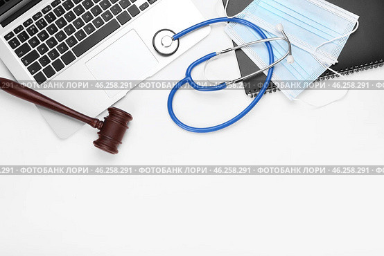 Judge gavel, laptop, masks and stethoscope on white background. Concept of health care reform. Стоковое фото, фотограф Pixel_shot / Фотобанк Лори