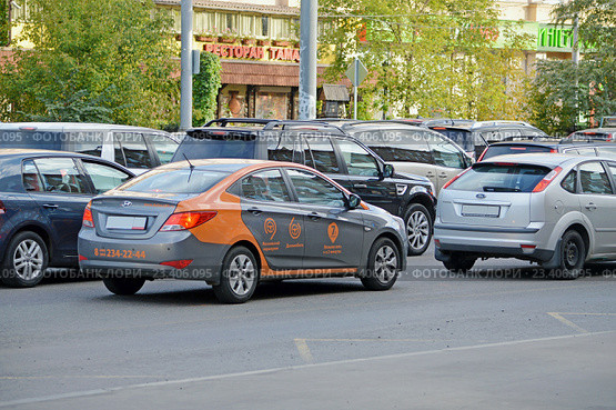 Каршеринг. Автомобиль сервиса поминутной аренды автомобиля "Делимобиль" в автомобильной пробке на улице Москве (2016 год). Редакционное фото, фотограф Александр Замараев / Фотобанк Лори