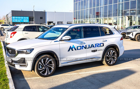 Китайский кроссовер Geely Monjaro рядом с офисом официального дилера. Редакционное фото, фотограф FotograFF / Фотобанк Лори