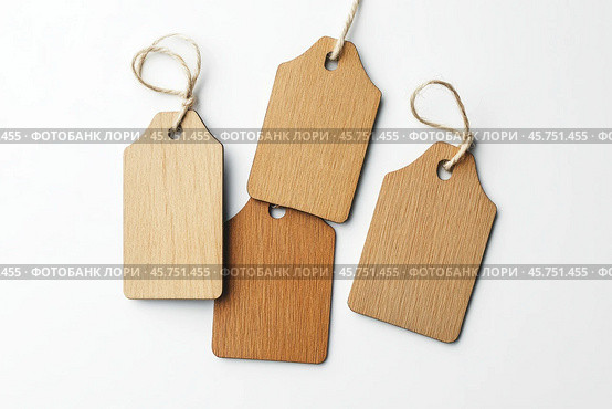 Label tag mockup. Wooden tag set hanging isolated on white background. Blank Gift or Price Tab with string cord knot. Price Label With Rope. Empty space for text. Price labeling or gift tagging. Sale. Стоковое AI-изображение, AI-художник Марина Демидюк / Фотобанк Лори