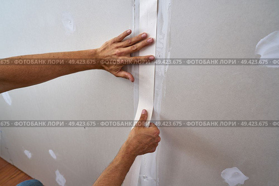 laminated plasterboard plastering join tape DIY detail. Стоковое фото, агентство Ingram Publishing / Фотобанк Лори