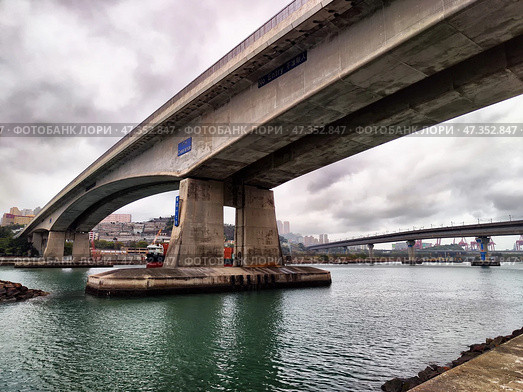 Lantau Island, Hong Kong - April 09, 2024: View of Lantau Island bridge under cloudy skies in Hong Kong's harbor area during daytime. Редакционное фото, фотограф Кривошеина Елена Леонидовна / Фотобанк Лори