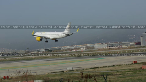 Large passenger airliner of Vueling Airlines with EC-NCS registration number landing in International El Prat Airport in Barcelona (2020 год). Редакционное видео, видеограф Яков Филимонов / Фотобанк Лори