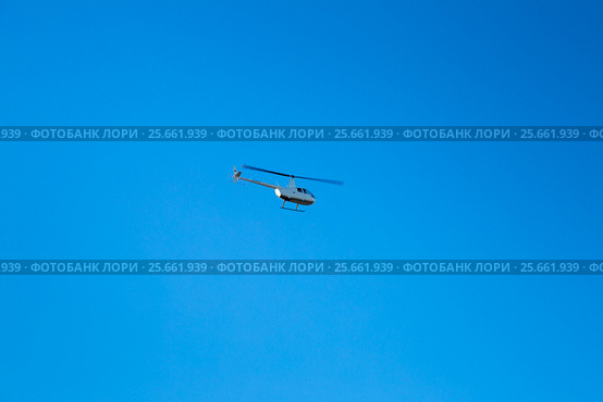 Легкий вертолет Robinson R44 Raven II (RA-06226) в синем небе (2016 год). Редакционное фото, фотограф Сергей Дубров / Фотобанк Лори