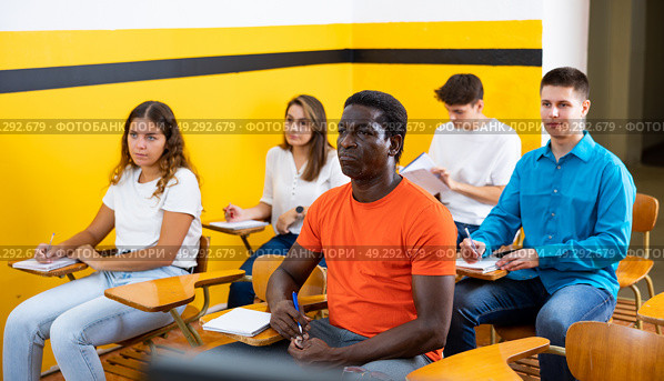 Lesson in the classroom of the driving school - students at their desks and take a theoretical course of work in taxi. Стоковое фото, фотограф Яков Филимонов / Фотобанк Лори