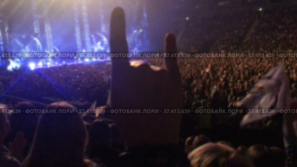 Light, strobes and a lot of hands are on rock or pop concert, scene with crowd of people. Стоковое видео, видеограф Кекяляйнен Андрей / Фотобанк Лори