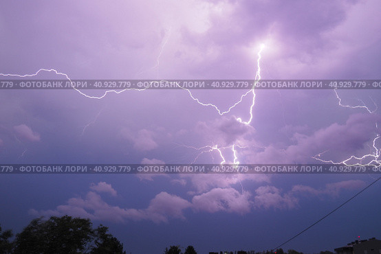 Lightning is a natural phenomenon electrostatic discharges in the atmosphere between two electrically charged regions, neutralizing in a near-instantaneous release of an average of gigajoule energy. Стоковое фото, фотограф Юлия Петровская / Фотобанк Лори
