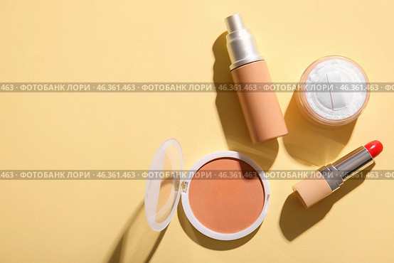 Liquid foundation, powder, lipstick and concealer on color background. Стоковое фото, фотограф Pixel_shot / Фотобанк Лори