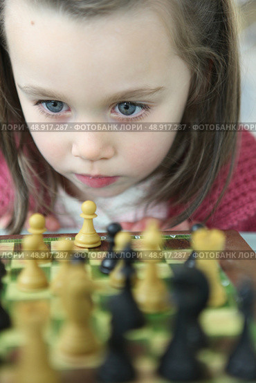 Little girl playing chess. Стоковое фото, агентство Ingram Publishing / Фотобанк Лори