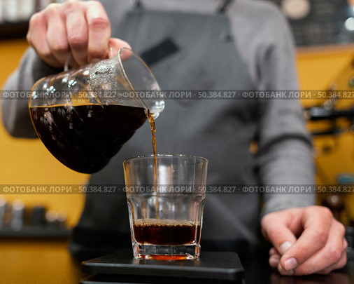 male barista pouring coffee transparent glass. Стоковое фото, агентство Ingram Publishing / Фотобанк Лори