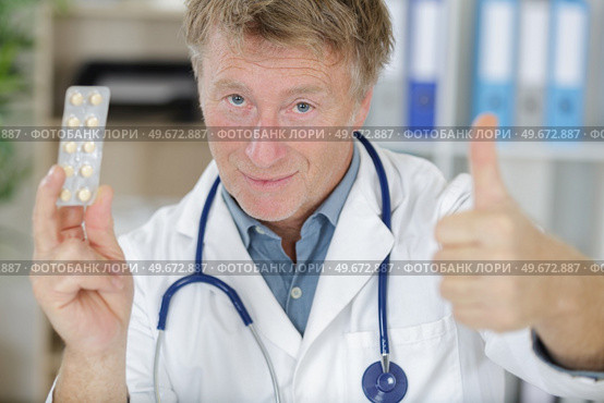 male doctor with packs of pills. Стоковое фото, агентство Ingram Publishing / Фотобанк Лори