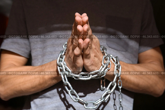 Male hostage with tied hands praying, closeup. Стоковое фото, фотограф Pixel_shot / Фотобанк Лори