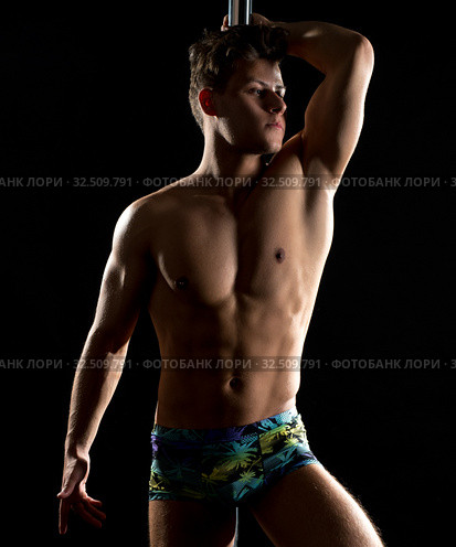 Male pole dance. Photo of muscular man posing. Стоковое фото, фотограф Гурьянов Андрей / Фотобанк Лори