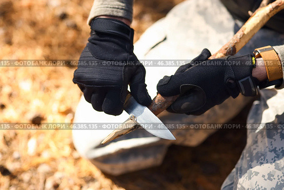 Male tourist making wooden stake in forest, closeup. Стоковое фото, фотограф Pixel_shot / Фотобанк Лори