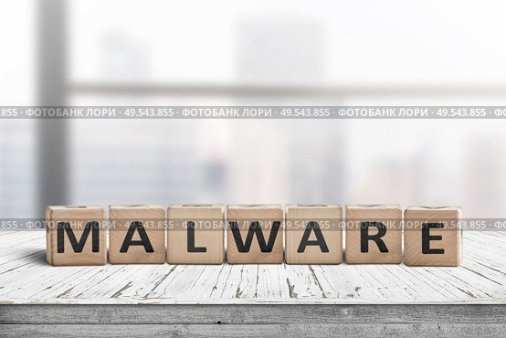 Malware message sign made of wood on a desk in a bright office environment. Стоковое фото, агентство Ingram Publishing / Фотобанк Лори