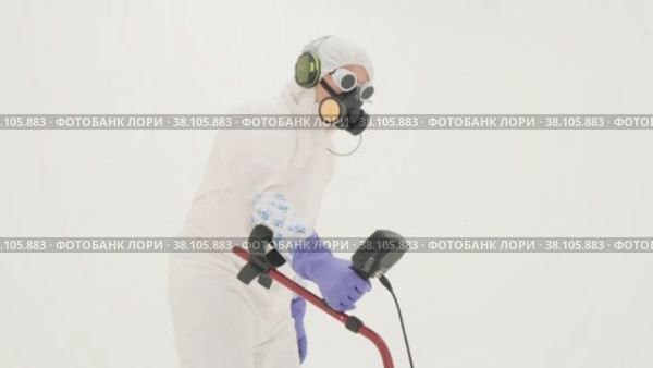Man in white chemical protection suit holds metal detector. Стоковое видео, видеограф Aleksey Kidisyuk / Фотобанк Лори