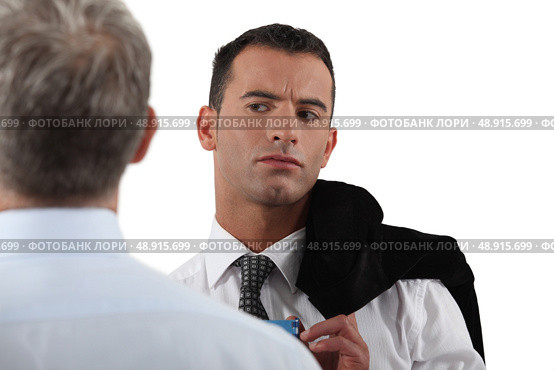 Man looking suspiciously at his colleague. Стоковое фото, агентство Ingram Publishing / Фотобанк Лори