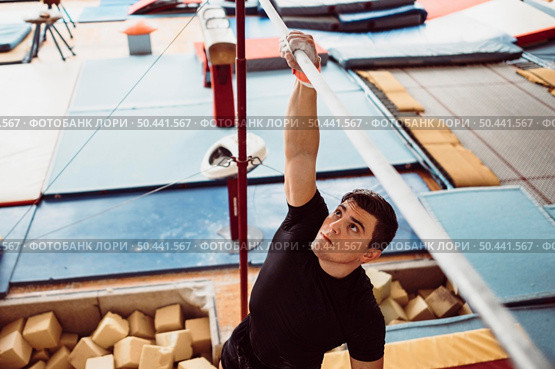 man training with parallel bars gymnastics championship. Стоковое фото, агентство Ingram Publishing / Фотобанк Лори