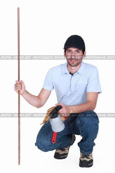 Man with copper pipe and a blowtorch. Стоковое фото, агентство Ingram Publishing / Фотобанк Лори