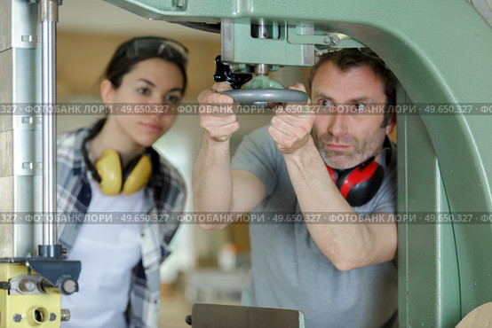 man working with female apprentice in factory. Стоковое фото, агентство Ingram Publishing / Фотобанк Лори