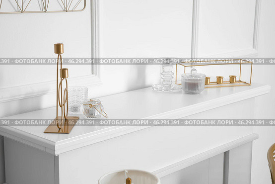 Mantelpiece with candle holders in stylish interior of room. Стоковое фото, фотограф Pixel_shot / Фотобанк Лори