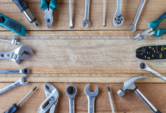 Many tools on old wooden panel. Стоковое фото, агентство Ingram Publishing / Фотобанк Лори