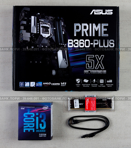 Maykop, Russia - November 9, 2018: Asus motherboard in box, intel I3 processor, Kingston Fury HyperX 16GB RAM and cable for connecting SATA 6gbs devices on grey background top view. Редакционное фото, фотограф Андрей С / Фотобанк Лори