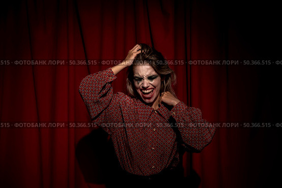 medium shot make up woman clown looking down. Стоковое фото, агентство Ingram Publishing / Фотобанк Лори