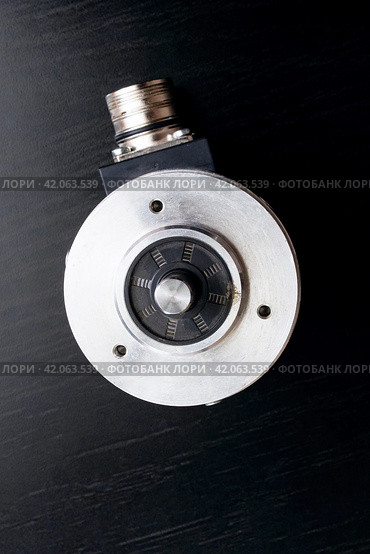 Metal encoder on a black wooden table. Стоковое фото, фотограф Аксенова Вера / Фотобанк Лори