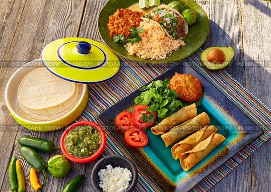 Mexican carnitas tacos with flautas from Mexico food ingredients. Стоковое фото, агентство Ingram Publishing / Фотобанк Лори