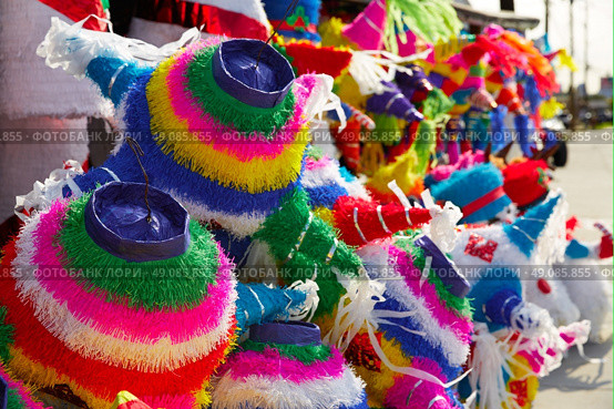 Mexican party pinatas decorated with fringed tissue colorful paper. Стоковое фото, агентство Ingram Publishing / Фотобанк Лори