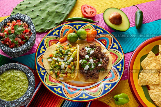 Mexican platillo tacos of barbacoa and vegetarian with sauces and colorful table. Стоковое фото, агентство Ingram Publishing / Фотобанк Лори