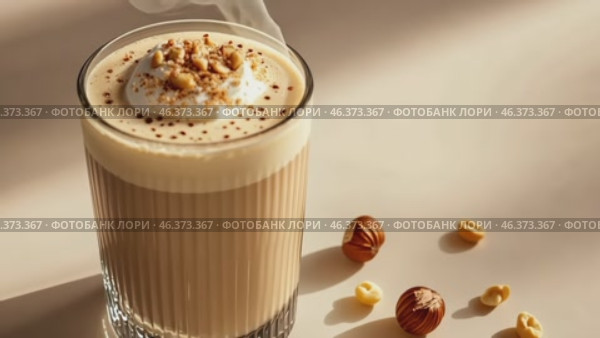 Mockup. Hot hazelnut coffee on a pale beige background. Space for text. Spice Latte or cappuccino. A rich and creamy hazelnut latte with a crumb of crushed nuts, served in a clear glass. Стоковое AI-видео, аниматор Марина Демидюк / Фотобанк Лори