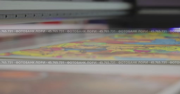 Modern Digital Large format UV printer. Printing production technologies. UV pinning is the process of applying a dose of low intensity ultraviolet light to a UV curable ink. Стоковое видео, видеограф Андрей Армягов / Фотобанк Лори