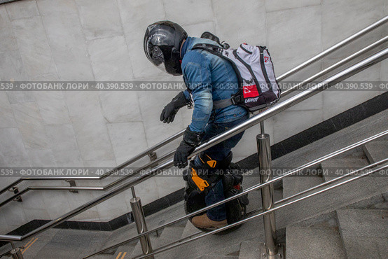 Молодой человек спускается на моноколесе в подземный пешеходный переход в центре города Москвы, Россия (2023 год). Редакционное фото, фотограф Николай Винокуров / Фотобанк Лори